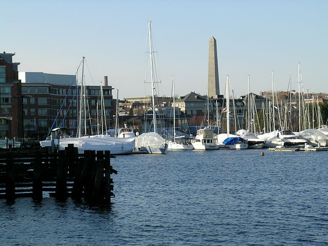 Sailboats moored on the Charlestown side of the Charles River with Bunker Hill Monument in the distance