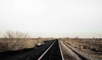 black train rail on the desert