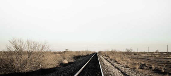 black train rail on the desert