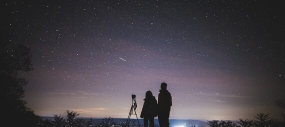 silhouette of two persons stargazing