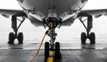gray air vehicle with yellow coated cable around docking wheels