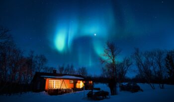 brown cottage under aurora borealis