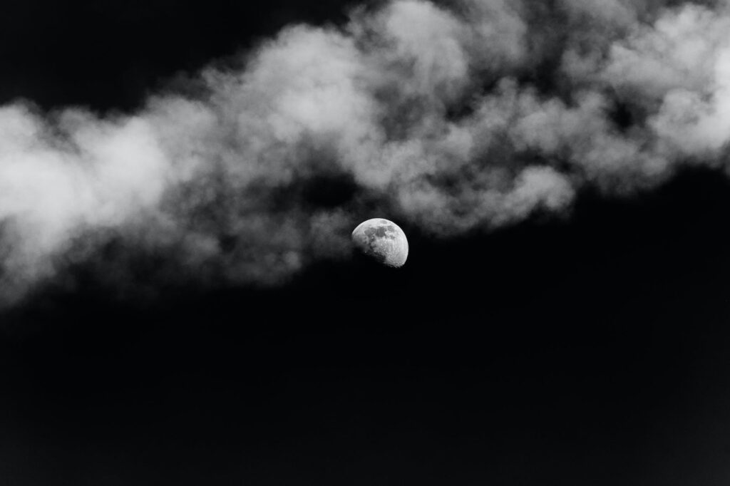 moon shining on dark sky with smoke