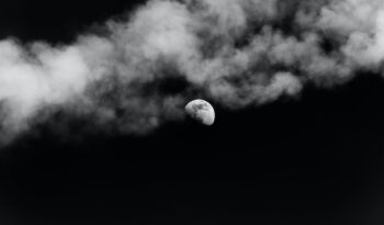 moon shining on dark sky with smoke