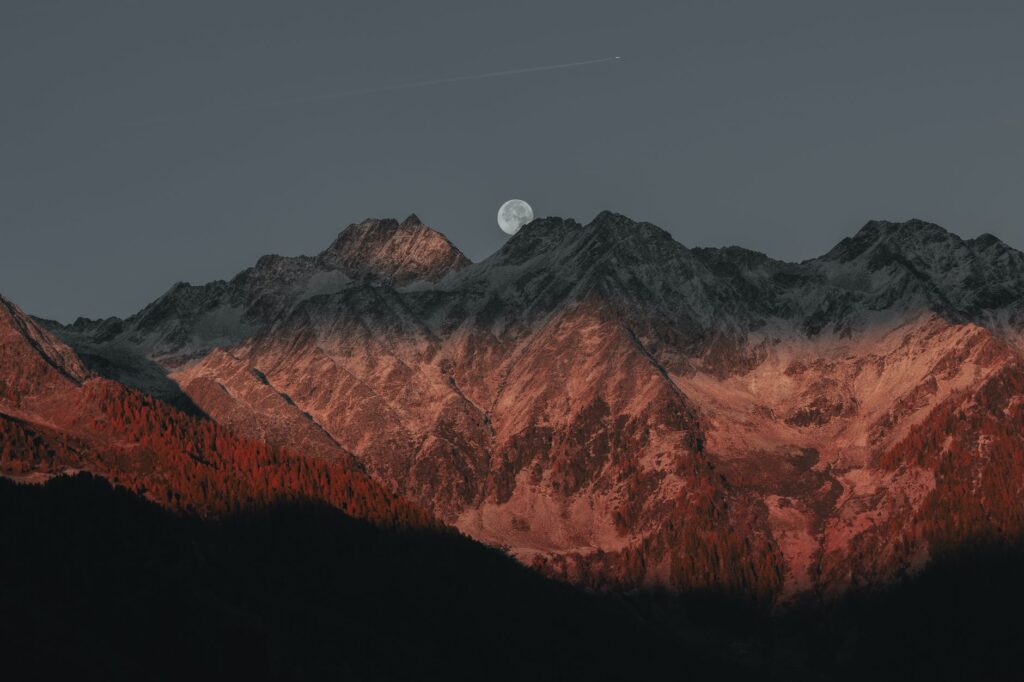 full moon behind mountains