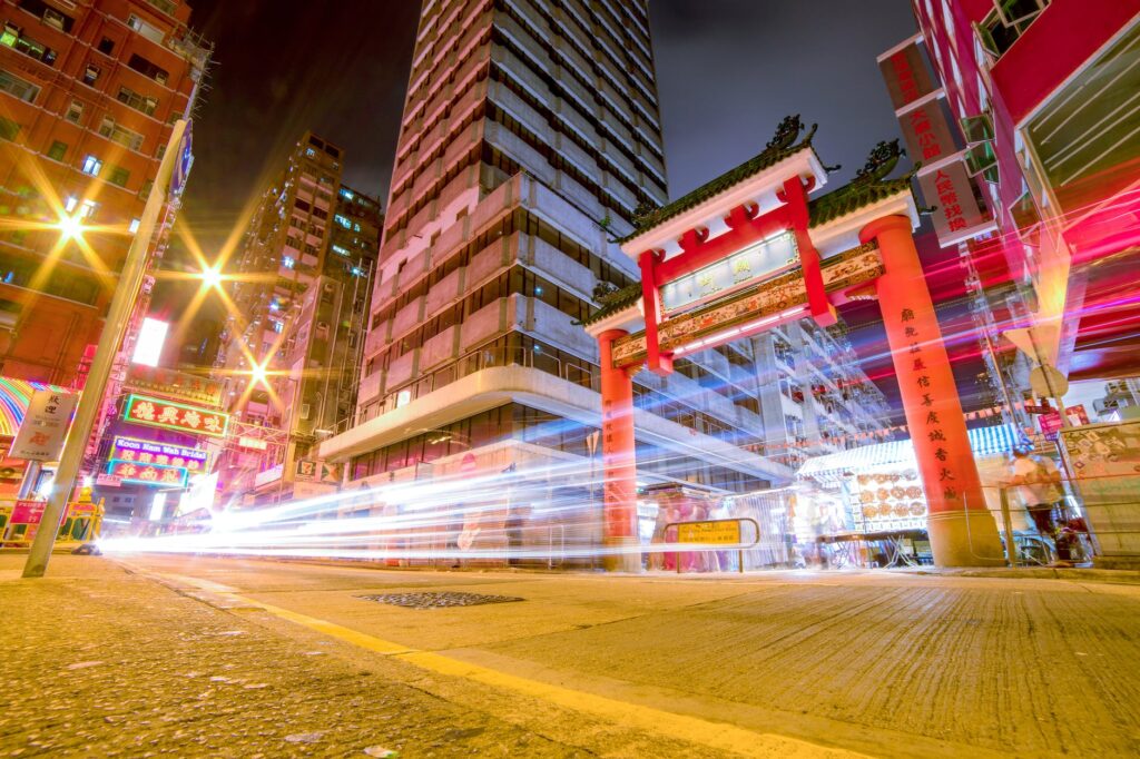 time lapse photography of vehicles passing through china town