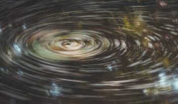 timelapse of water around a whirlpool in a pond