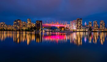 a scenic view of the bc place stadium and vancouver skyline at night