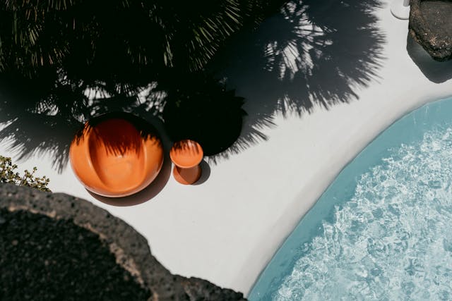 https://www.pexels.com/photo/photo-of-a-seat-next-to-a-swimming-pool-15173066/